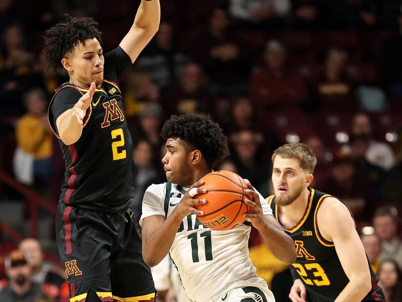 Dec 4, 2024; Minneapolis, Minnesota, USA; Michigan State Spartans guard Jase Richardson (11) works around Minnesota Golden Gophers guard Mike Mitchell Jr. (2) during the first half at Williams Arena. Mandatory Credit: Matt Krohn-Imagn Images