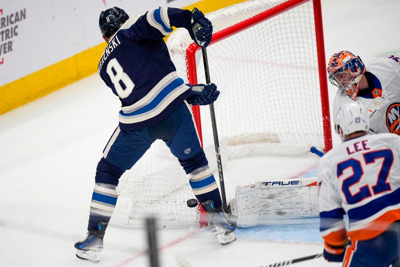 Oct 30, 2024; Columbus, Ohio, USA; Columbus Blue Jackets defenseman Zach Werenski (8) attempts to shoot the puck against the New York Islanders in the second period at Nationwide Arena. Mandatory Credit: Samantha Madar-Imagn Images