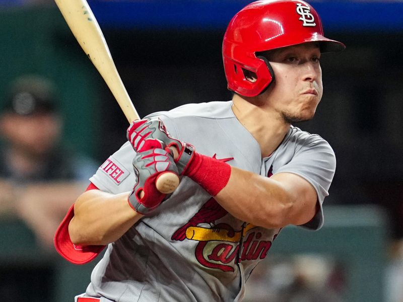 Aug 11, 2023; Kansas City, Missouri, USA; St. Louis Cardinals shortstop Tommy Edman (19) hits a double during the sixth inning against the Kansas City Royals at Kauffman Stadium. Mandatory Credit: Jay Biggerstaff-USA TODAY Sports