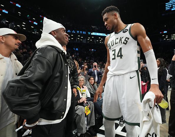 BROOKLYN, NY - DECEMBER 27: Vinicius Junior greets Giannis Antetokounmpo #34 of the Milwaukee Bucks after the game against the Brooklyn Nets on December 27, 2023 at Barclays Center in Brooklyn, New York. NOTE TO USER: User expressly acknowledges and agrees that, by downloading and or using this Photograph, user is consenting to the terms and conditions of the Getty Images License Agreement. Mandatory Copyright Notice: Copyright 2023 NBAE (Photo by Jesse D. Garrabrant/NBAE via Getty Images)