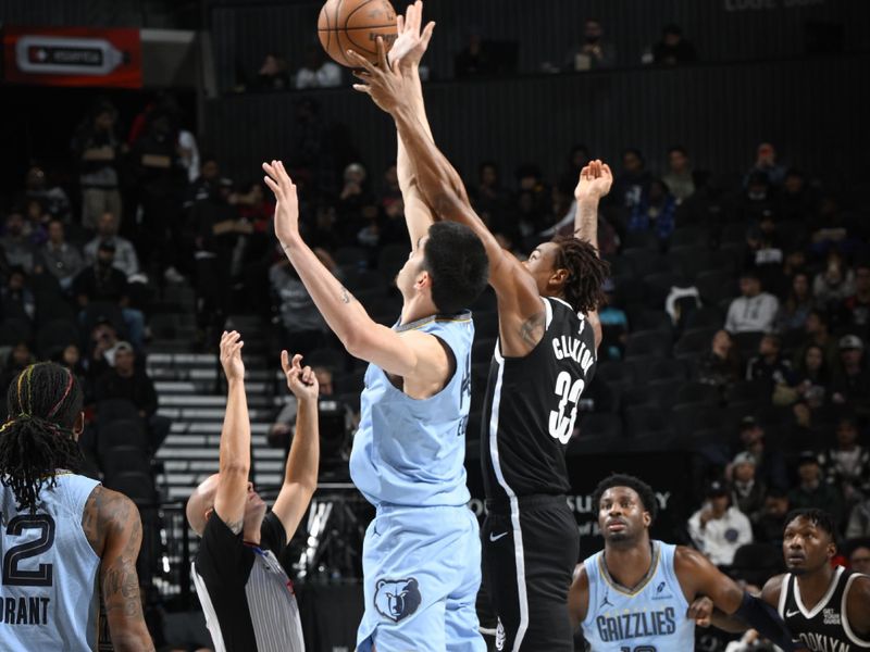 BROOKLYN, NY - NOVEMBER 4: Zach Edey #14 of the Memphis Grizzlies and Nicolas Claxton #33 of the Brooklyn Nets go for the opening tip-off during the game on November 4, 2024 at Barclays Center in Brooklyn, New York. NOTE TO USER: User expressly acknowledges and agrees that, by downloading and or using this Photograph, user is consenting to the terms and conditions of the Getty Images License Agreement. Mandatory Copyright Notice: Copyright 2024 NBAE (Photo by David Dow<p><br/></p>/NBAE via Getty Images)