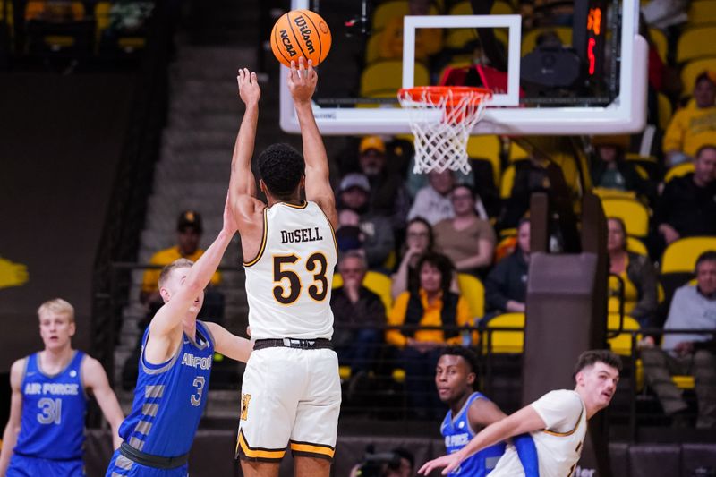 Feb 17, 2023; Laramie, Wyoming, USA; Wyoming Cowboys guard Xavier DuSell (53) shoots a three point basket against Air Force Falcons guard Jake Heidbreder (3) during the first half at Arena-Auditorium. Mandatory Credit: Troy Babbitt-USA TODAY Sports