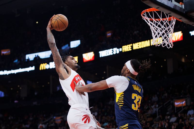 TORONTO, CANADA - APRIL 9: Malik Williams #35 of the Toronto Raptors drives to the net against Myles Turner #33 of the Indiana Pacers during the first half of their NBA game at Scotiabank Arena on April 9, 2024 in Toronto, Canada. NOTE TO USER: User expressly acknowledges and agrees that, by downloading and or using this photograph, User is consenting to the terms and conditions of the Getty Images License Agreement. (Photo by Cole Burston/Getty Images)