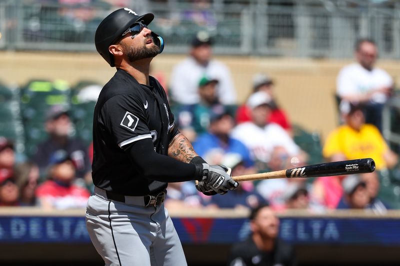 Apr 25, 2024; Minneapolis, Minnesota, USA; Chicago White Sox center fielder Kevin Pillar (12) hits an RBI sacrifice fly against the Minnesota Twins during the second inning at Target Field. Mandatory Credit: Matt Krohn-USA TODAY Sports