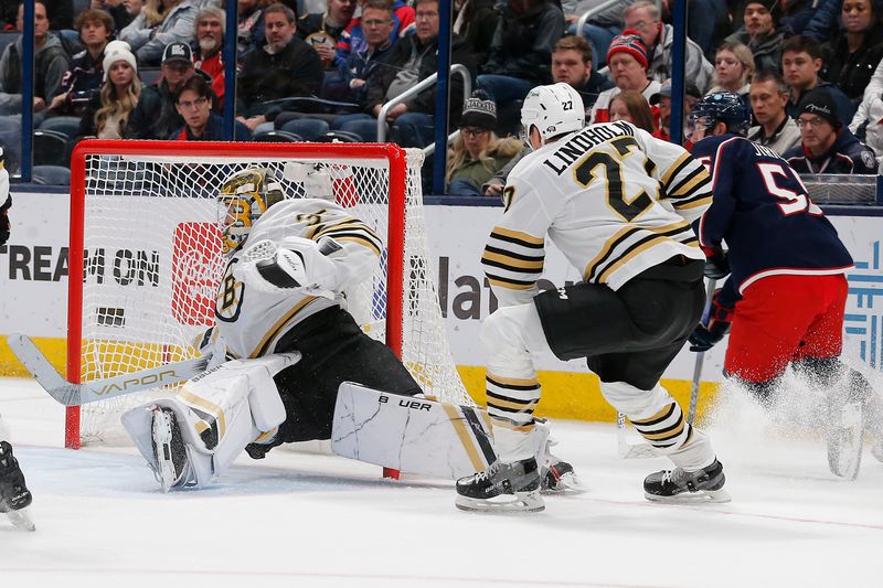 Jan 2, 2024; Columbus, Ohio, USA; Columbus Blue Jackets defenseman David Jiricek (55) carries the puck behind the net as Boston Bruins goalie Linus Ullmark (35) looses an edge during the third period at Nationwide Arena. Mandatory Credit: Russell LaBounty-USA TODAY Sports