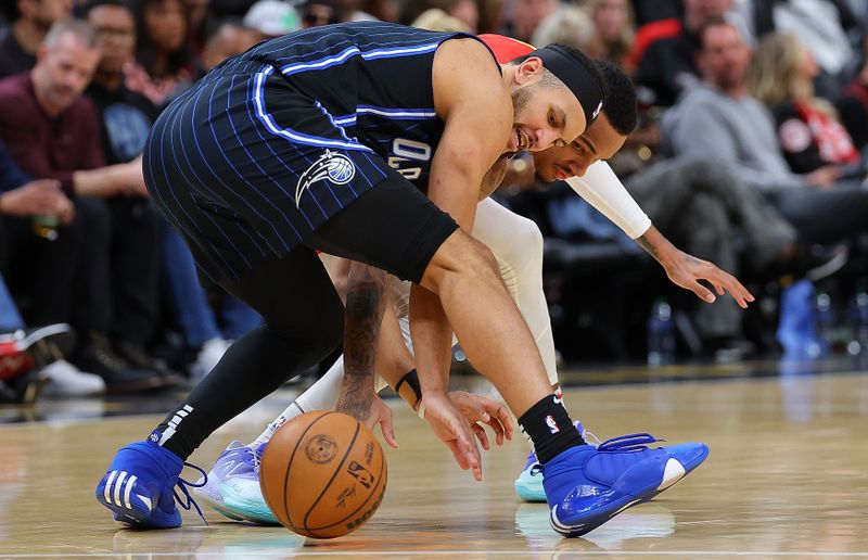 ATLANTA, GEORGIA - FEBRUARY 25:  Jalen Suggs #4 of the Orlando Magic steals the ball from Dejounte Murray #5 of the Atlanta Hawks during the fourth quarter at State Farm Arena on February 25, 2024 in Atlanta, Georgia.  NOTE TO USER: User expressly acknowledges and agrees that, by downloading and/or using this photograph, user is consenting to the terms and conditions of the Getty Images License Agreement.  (Photo by Kevin C. Cox/Getty Images)