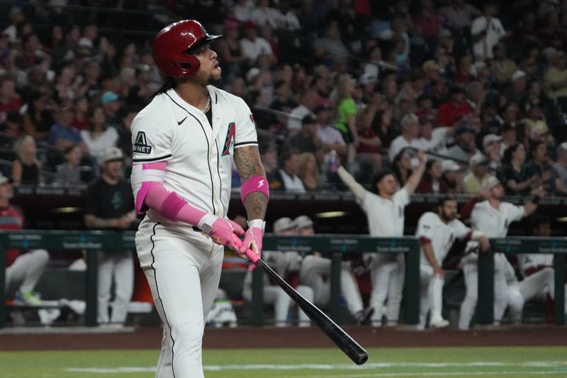 May 18, 2025; Phoenix, Arizona, USA; Arizona Diamondbacks second base Ketel Marte (4) hits a solo home run against the Colorado Rockies in the first inning at Chase Field. Mandatory Credit: Rick Scuteri-Imagn Images