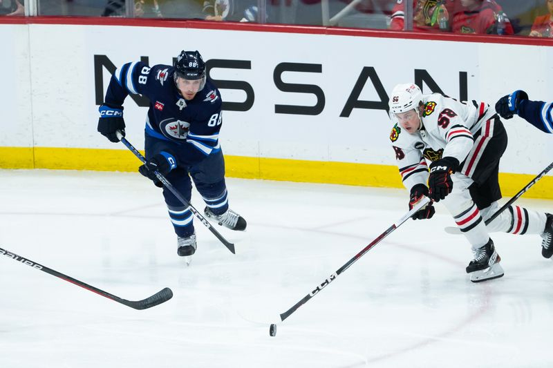 Jan 11, 2024; Winnipeg, Manitoba, CAN; Winnipeg Jets defenseman Nate Schmidt (88) and Chicago Blackhawks forward MacKenzie Entwistle (58) skate after the puck during the third period at Canada Life Centre. Mandatory Credit: Terrence Lee-USA TODAY Sports