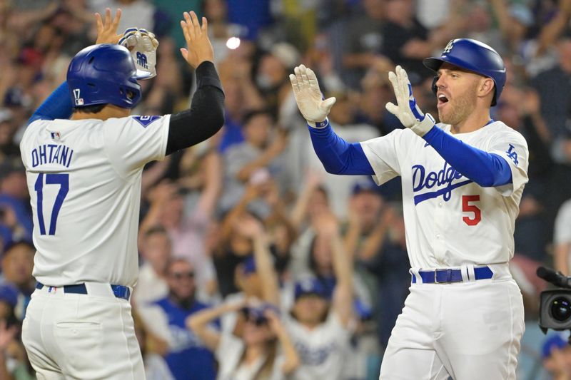 Jul 19, 2024; Los Angeles, California, USA;  Los Angeles Dodgers first base Freddie Freeman (5) is congratulated by designated hitter Shohei Ohtani (17) after hitting a grand slam home run in the eighth inning against the Boston Red Sox at Dodger Stadium. Mandatory Credit: Jayne Kamin-Oncea-USA TODAY Sports
