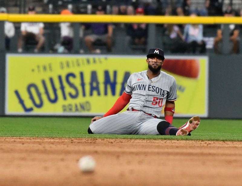 Sep 30, 2023; Denver, Colorado, USA; Minnesota Twins shortstop Willi Castro (50) watches his throw to first base to get Colorado Rockies second baseman Brendan Rodgers  for the out in the third inning at Coors Field. Mandatory Credit: John Leyba-USA TODAY Sports