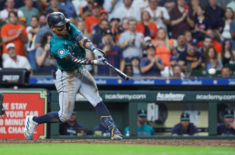 Sep 23, 2024; Houston, Texas, USA; Seattle Mariners center fielder Julio Rodriguez (44) hits an RBI single during the seventh inning against the Houston Astros at Minute Maid Park. Mandatory Credit: Troy Taormina-Imagn Images