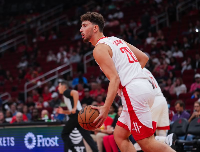 HOUSTON, TEXAS - OCTOBER 10: Alperen Sengun #28 of the Houston Rockets dribbles the ball during the preseason game against the Indiana Pacers at Toyota Center on October 10, 2023 in Houston, Texas. NOTE TO USER: User expressly acknowledges and agrees that, by downloading and or using this photograph, User is consenting to the terms and conditions of the Getty Images License Agreement. (Photo by Alex Bierens de Haan/Getty Images)