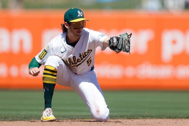 May 22, 2025; West Sacramento, California, USA; Athletics shortstop Jacob Wilson (5) catches a line drive for an out during the eighth inning against the Los Angeles Angels at Sutter Health Park. Mandatory Credit: Sergio Estrada-Imagn Images