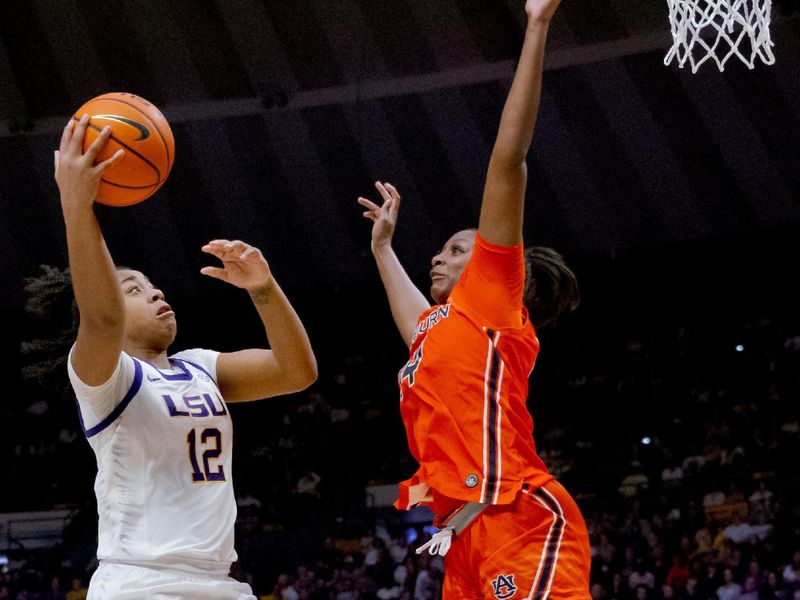 Feb 22, 2024; Baton Rouge, Louisiana, USA;  LSU Lady Tigers guard Mikaylah Williams (12) shoots against Auburn Tigers forward Taylen Collins (14) during the second half at Pete Maravich Assembly Center. Mandatory Credit: Matthew Hinton-USA TODAY Sports