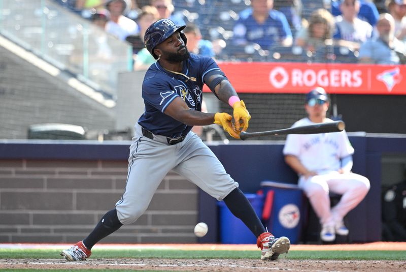 Jul 25, 2024; Toronto, Ontario, CAN; Tampa Bay Rays left fielder Randy Arozarena (56) loses his grip on his bat as he fouls a pitch off against the Toronto Blue Jays in the seventh inning at Rogers Centre. Mandatory Credit: Dan Hamilton-USA TODAY Sports