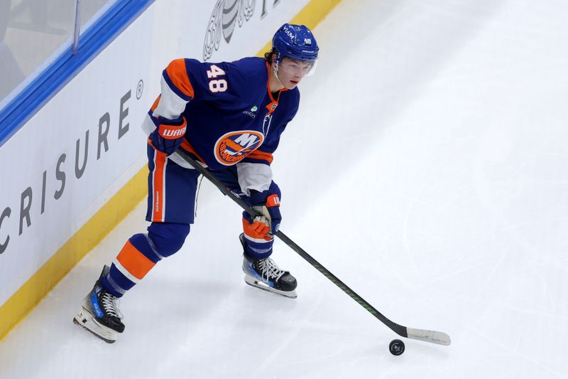 Oct 11, 2025; Elmont, New York, USA; New York Islanders defenseman Matthew Schaefer (48) controls the puck against the Washington Capitals during the first period at UBS Arena. Mandatory Credit: Brad Penner-Imagn Images