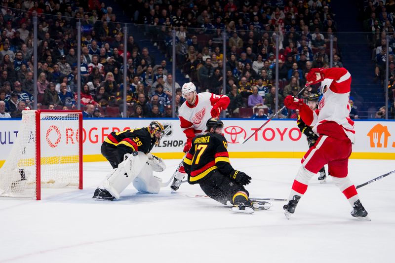 Feb 15, 2024; Vancouver, British Columbia, CAN;  Detroit Red Wings forward Christian Fischer (36) watches as Detroit Red Wings forward J.T. Compher (37) scores on Vancouver Canucks goalie Thatcher Demko (35) behind sliding defenseman Filip Hronek (17) in the second period at Rogers Arena. Mandatory Credit: Bob Frid-USA TODAY Sports