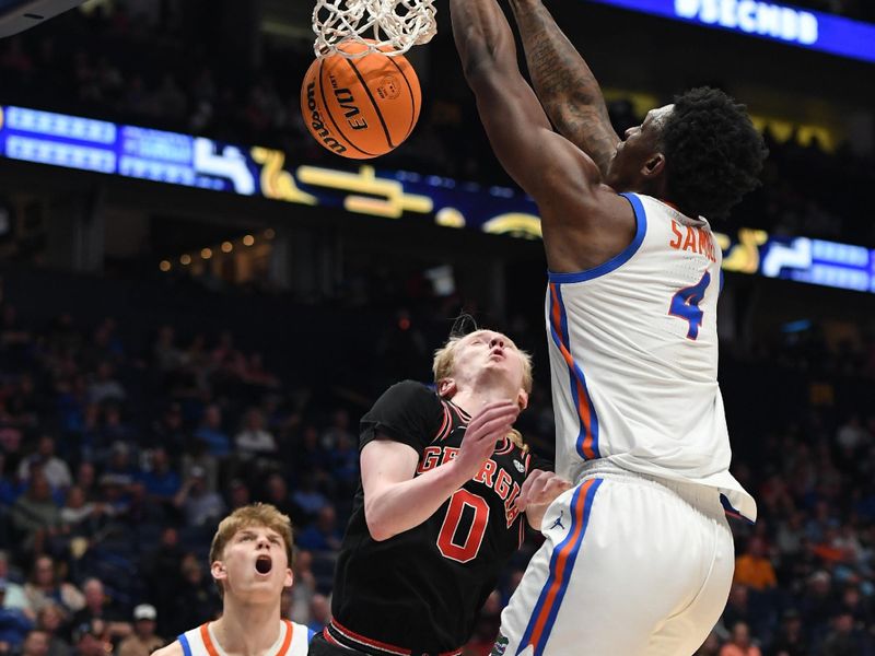 Mar 14, 2024; Nashville, TN, USA; Florida Gators forward Tyrese Samuel (4) dunks against Georgia Bulldogs guard Blue Cain (0) during the first half at Bridgestone Arena. Mandatory Credit: Christopher Hanewinckel-USA TODAY Sports