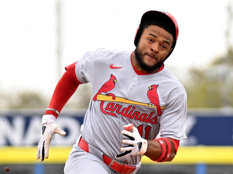 Feb 25, 2025; Dunedin, Florida, USA; St. Louis Cardinals left fielder Victor Scott II (11) heads for third base for a triple against the Toronto Blue Jays in the first inning of a spring training game at TD Ballpark. Mandatory Credit: Jonathan Dyer-Imagn Images