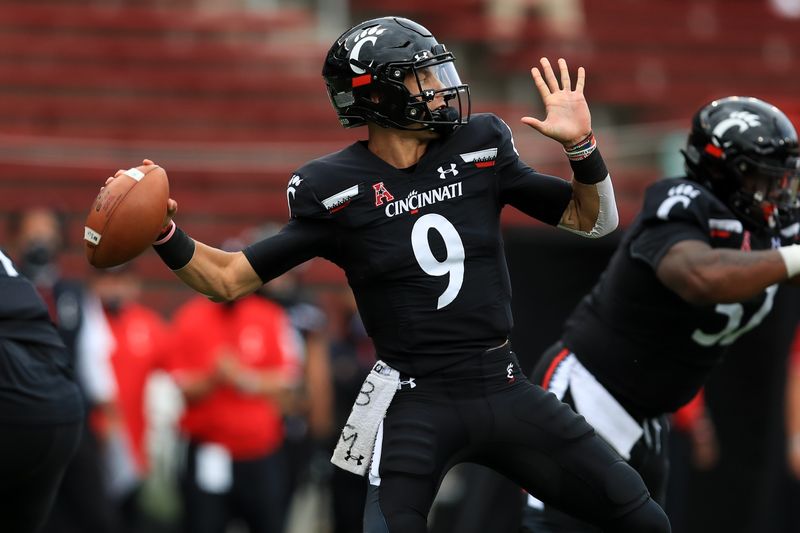 Sep 26, 2020; Cincinnati, Ohio, USA; Cincinnati Bearcats quarterback Desmond Ridder (9) throws a pass against the Army Black Knights in the first half at Nippert Stadium. Mandatory Credit: Aaron Doster-USA TODAY Sports