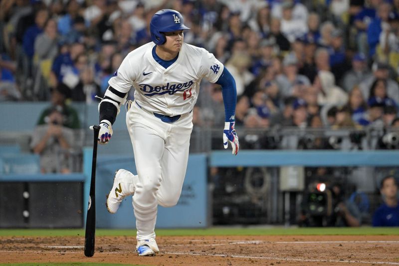 Sep 26, 2024; Los Angeles, California, USA;  Los Angeles Dodgers designated hitter Shohei Ohtani (17) singles in the sixth inning against the San Diego Padres at Dodger Stadium. Mandatory Credit: Jayne Kamin-Oncea-Imagn Images