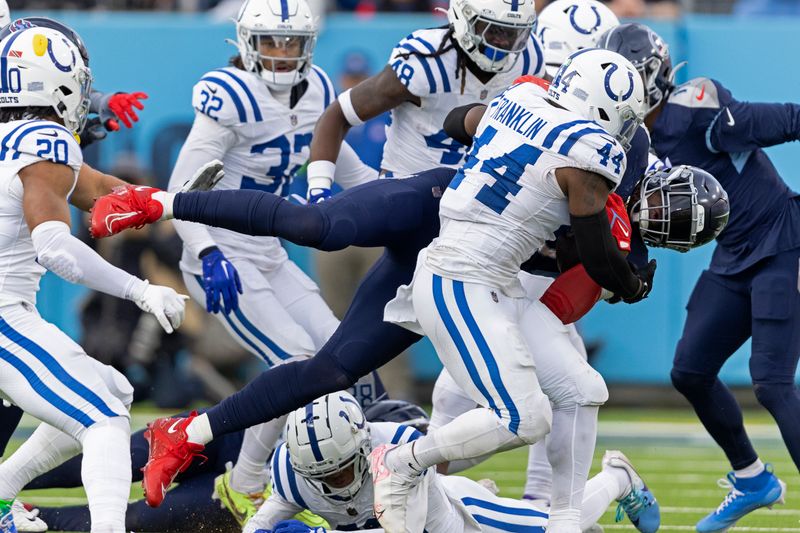 Tennessee Titans running back Derrick Henry (22) in upended as he runs for yardage as he's tackled by Indianapolis Colts linebacker Zaire Franklin (44) during their NFL football game Sunday, Dec. 3, 2023, in Nashville, Tenn. (AP Photo/Wade Payne)