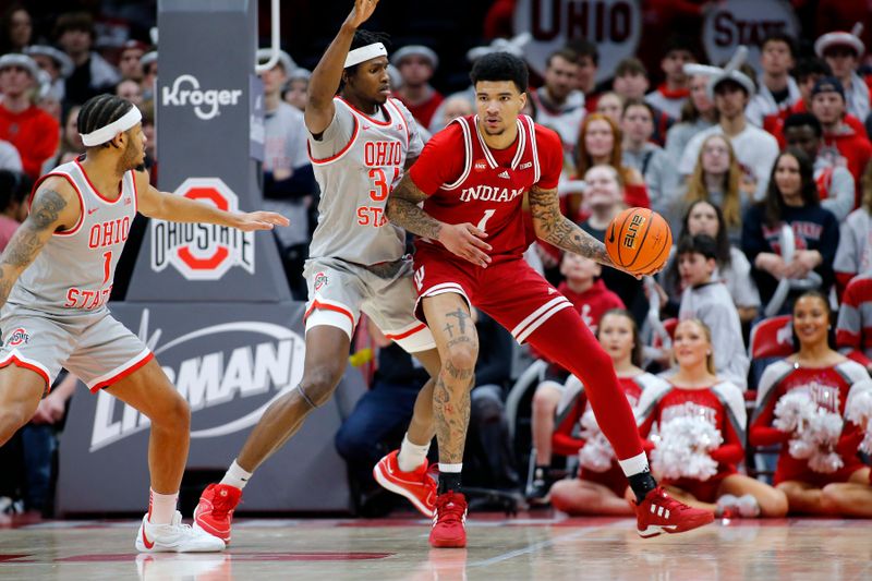 Feb 6, 2024; Columbus, Ohio, USA;  Indiana Hoosiers center Kel'el Ware (1) controls the ball as Ohio State Buckeyes center Felix Okpara (34) defends during the second half at Value City Arena. Mandatory Credit: Joseph Maiorana-USA TODAY Sports