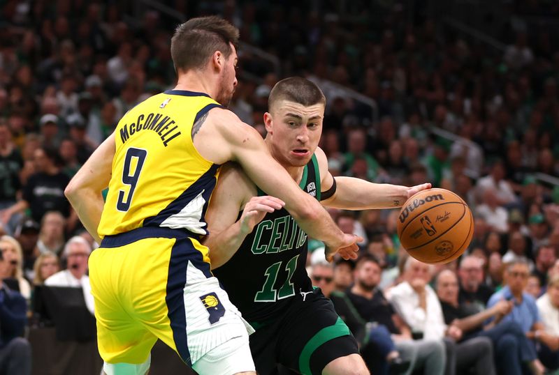 BOSTON, MASSACHUSETTS - MAY 23: Payton Pritchard #11 of the Boston Celtics drives past T.J. McConnell #9 of the Indiana Pacers during the fourth quarter in Game Two of the Eastern Conference Finals at TD Garden on May 23, 2024 in Boston, Massachusetts. NOTE TO USER: User expressly acknowledges and agrees that, by downloading and or using this photograph, User is consenting to the terms and conditions of the Getty Images License Agreement. (Photo by Maddie Meyer/Getty Images)