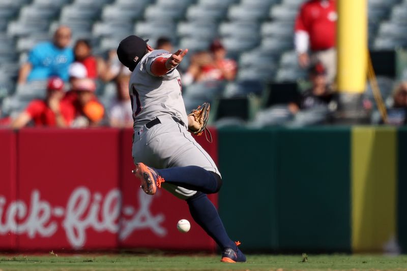 Sep 15, 2024; Anaheim, California, USA;  Houston Astros second baseman Jose Altuve (21) falls trying to catch the ball during the ninth inning against the Los Angeles Angels at Angel Stadium. Mandatory Credit: Kiyoshi Mio-Imagn Images