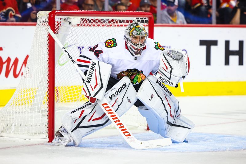 Oct 15, 2024; Calgary, Alberta, CAN; Chicago Blackhawks goaltender Petr Mrazek (34) guards his net against the Calgary Flames during the second period at Scotiabank Saddledome. Mandatory Credit: Sergei Belski-Imagn Images