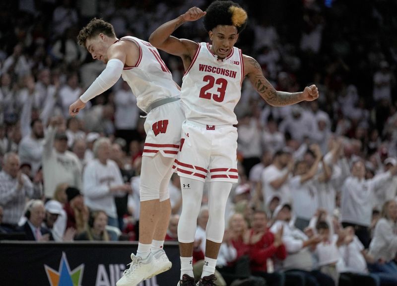 Dec 2, 2023; Madison, Wisconsin, USA; Wisconsin Badgers guard Max Klesmit (11) celebrates with guard Chucky Hepburn (23) after a three-point basket against the Marquette Golden Eagles during the first half at the Kohl Center in Madison. Mandatory Credit: Mark Hoffman/Milwaukee Journal Sentinel via USA TODAY NETWORK