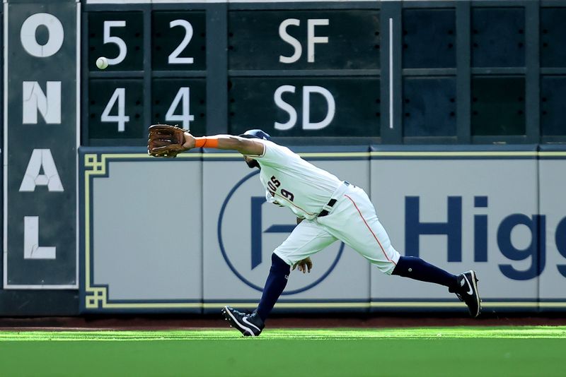 Apr 29, 2023; Houston, Texas, USA; Houston Astros outfielder Corey Julks (9) stretches to catch a fly ball for an out against the Philadelphia Phillies during the first inning at Minute Maid Park. Mandatory Credit: Erik Williams-USA TODAY Sports