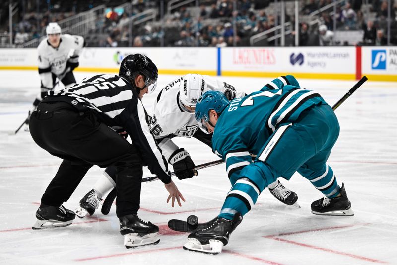 Oct 29, 2024; San Jose, California, USA; San Jose Sharks center Nico Sturm (7) and Los Angeles Kings center Akil Thomas (26) face off in the first period at SAP Center at San Jose. Mandatory Credit: Eakin Howard-Imagn Images