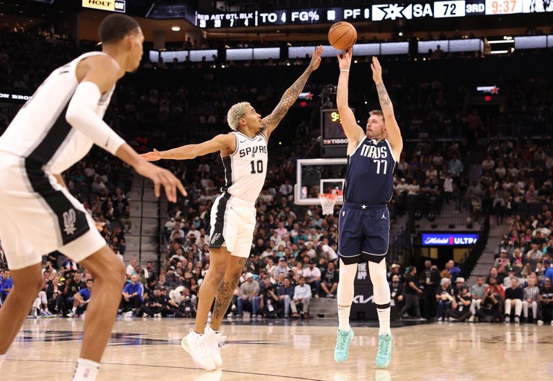 SAN ANTONIO, TEXAS - OCTOBER 25: Luka Doncic #77 of the Dallas Mavericks shoots over Jeremy Sochan #10 of the San Antonio Spurs during the third quarter at Frost Bank Center on October 25, 2023 in San Antonio, Texas. NOTE TO USER: User expressly acknowledges and agrees that, by downloading and/or using this Photograph, user is consenting to the terms and conditions of the Getty Images License Agreement. (Photo by Christian Petersen/Getty Images)