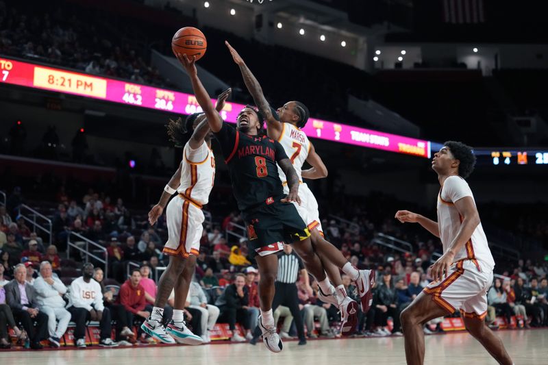 Jan 13, 2026; Los Angeles, California, USA; Maryland Terrapins guard David Coit (8) shoots the ball against Southern California Trojans guard Kam Woods (13) and guard Jordan Marsh (7) in the first half at Galen Center. Mandatory Credit: Kirby Lee-Imagn Images