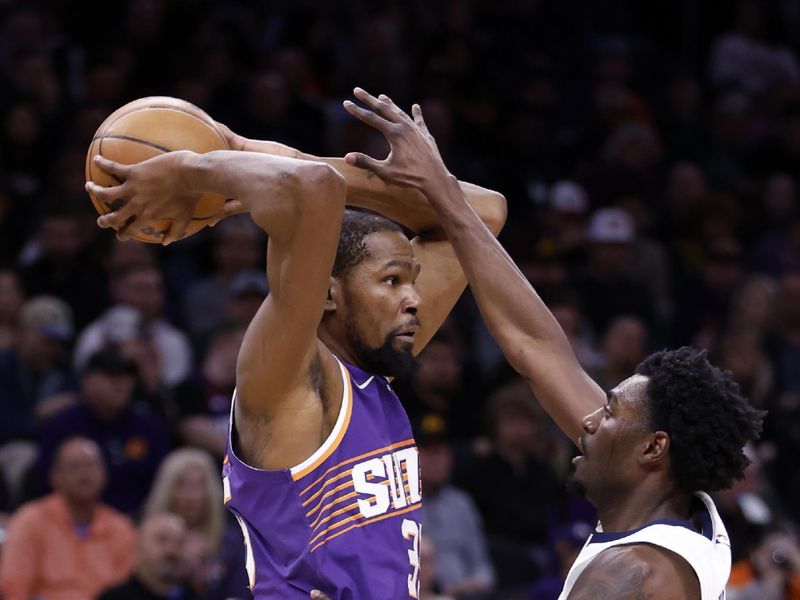 PHOENIX, ARIZONA - JANUARY 07: Kevin Durant #35 of the Phoenix Suns passes around Vince Williams Jr. #5 of the Memphis Grizzlies during the first half at Footprint Center on January 07, 2024 in Phoenix, Arizona. NOTE TO USER: User expressly acknowledges and agrees that, by downloading and or using this photograph, User is consenting to the terms and conditions of the Getty Images License Agreement.  (Photo by Chris Coduto/Getty Images)