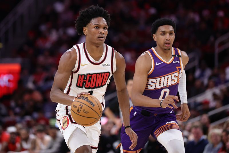 HOUSTON, TEXAS - FEBRUARY 12: Amen Thompson #1 of the Houston Rockets drives against Ryan Dunn #0 of the Phoenix Suns during the first half at Toyota Center on February 12, 2025 in Houston, Texas. NOTE TO USER: User expressly acknowledges and agrees that, by downloading and or using this photograph, User is consenting to the terms and conditions of the Getty Images License Agreement. (Photo by Alex Slitz/Getty Images)