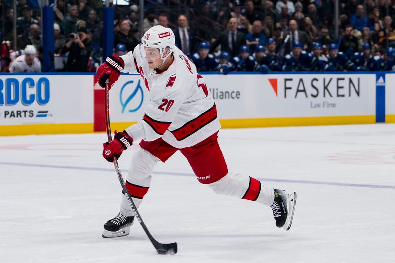 Dec 9, 2023; Vancouver, British Columbia, CAN; Carolina Hurricanes forward Sebastian Aho (20) shoots against the Vancouver Canucks in the second period at Rogers Arena. Mandatory Credit: Bob Frid-USA TODAY Sports