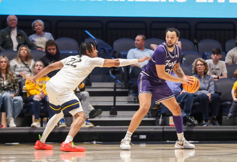 Mar 6, 2024; Morgantown, West Virginia, USA; TCU Horned Frogs forward JaKobe Coles (21) looks to pass while defended by West Virginia Mountaineers forward Josiah Harris (22) during the second half at WVU Coliseum. Mandatory Credit: Ben Queen-USA TODAY Sports