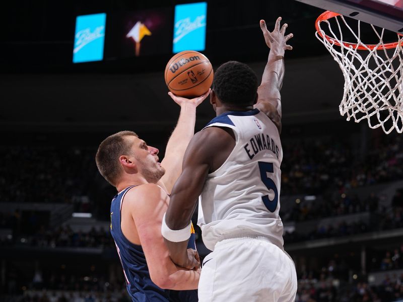 DENVER, CO - APRIL 10: Nikola Jokic #15 of the Denver Nuggets drives to the basket against Anthony Edwards #5 of the Minnesota Timberwolves during the game on April 10, 2024 at the Ball Arena in Denver, Colorado. NOTE TO USER: User expressly acknowledges and agrees that, by downloading and/or using this Photograph, user is consenting to the terms and conditions of the Getty Images License Agreement. Mandatory Copyright Notice: Copyright 2024 NBAE (Photo by Bart Young/NBAE via Getty Images)