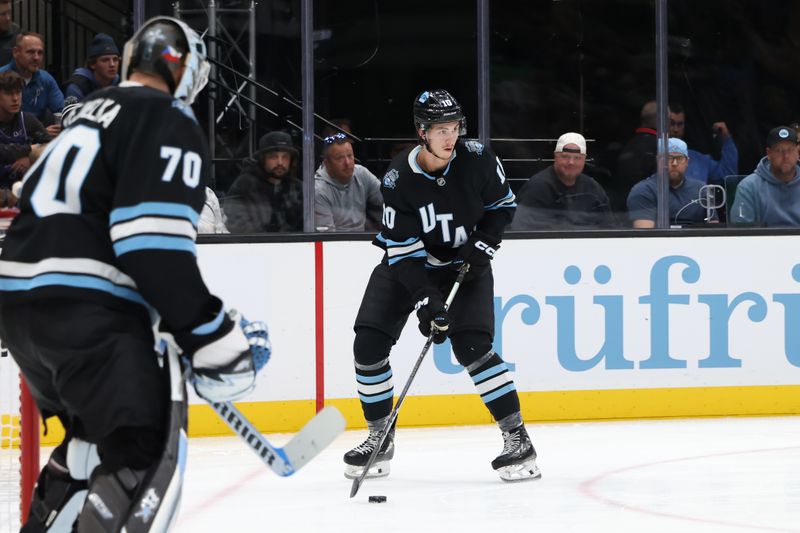 Oct 24, 2024; Salt Lake City, Utah, USA; Utah Hockey Club defenseman Maveric Lamoureux (10) controls the puck against the Colorado Avalanche during the third period at Delta Center. Mandatory Credit: Rob Gray-Imagn Images