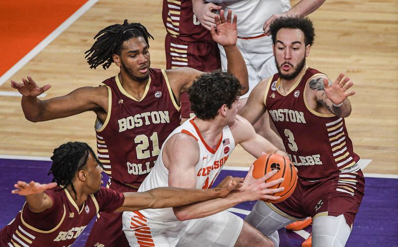 Jan 13, 2024; Clemson, South Carolina, USA; Clemson Tigers forward PJ Hall (24) controls the ball against Boston College Eagles forward Devin McGlockton (21) and guard Jaeden Zackery (3) during the first half at Littlejohn Coliseum. Mandatory Credit: Ken Ruinard-USA TODAY Sports