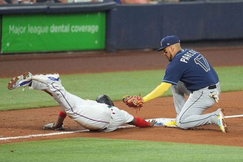 Aug 30, 2023; Miami, Florida, USA; Tampa Bay Rays third baseman Isaac Paredes (17) tags out Miami Marlins right fielder Jesus Sanchez (7) in the fifth inning at loanDepot Park. Mandatory Credit: Jim Rassol-USA TODAY Sports