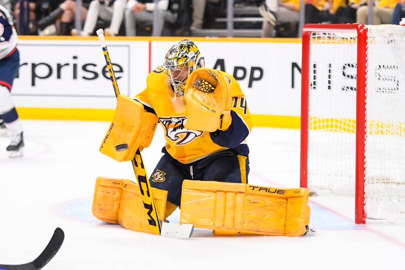 Apr 13, 2024; Nashville, Tennessee, USA; Nashville Predators goaltender Juuse Saros (74) blocks the puck against the Columbus Blue Jackets during the second period at Bridgestone Arena. Mandatory Credit: Steve Roberts-USA TODAY Sports