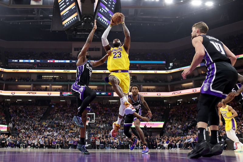 SACRAMENTO, CALIFORNIA - MARCH 13: LeBron James #23 of the Los Angeles Lakers goes up for a shot on Harrison Barnes #40 of the Sacramento Kings in the first half at Golden 1 Center on March 13, 2024 in Sacramento, California. NOTE TO USER: User expressly acknowledges and agrees that, by downloading and or using this photograph, User is consenting to the terms and conditions of the Getty Images License Agreement.  (Photo by Ezra Shaw/Getty Images)