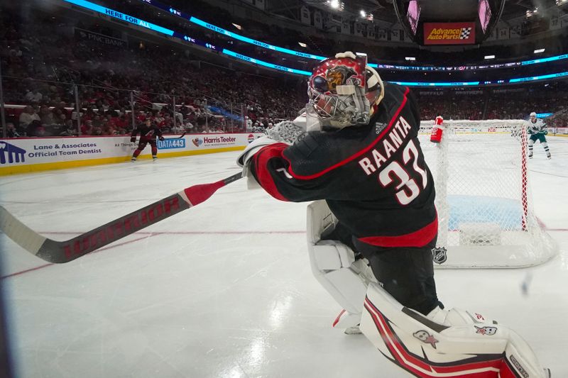 Oct 27, 2023; Raleigh, North Carolina, USA; Carolina Hurricanes goaltender Antti Raanta (32) clears the puck away against the San Jose Sharks during the second period at PNC Arena. Mandatory Credit: James Guillory-USA TODAY Sports