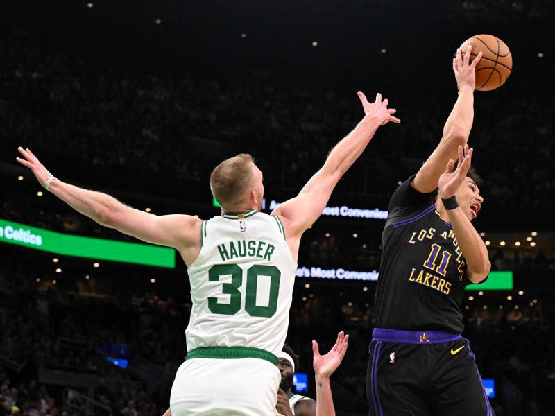 BOSTON, MASSACHUSETTS - FEBRUARY 01: Jaxson Hayes #11 of the Los Angeles Lakers passes the ball in front of Sam Hauser #30 of the Boston Celtics during the second quarter at the TD Garden on February 01, 2024 in Boston, Massachusetts. NOTE TO USER: User expressly acknowledges and agrees that, by downloading and or using this photograph, User is consenting to the terms and conditions of the Getty Images License Agreement. (Photo by Brian Fluharty/Getty Images)