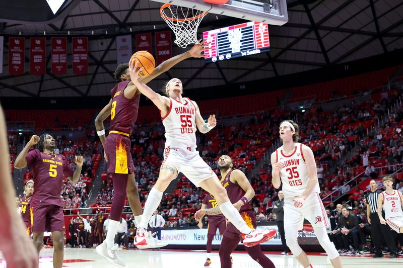 Feb 10, 2024; Salt Lake City, Utah, USA; Utah Utes guard Gabe Madsen (55) goes to the basket against Arizona State Sun Devils forward Alonzo Gaffney (8) during the second half at Jon M. Huntsman Center. Mandatory Credit: Rob Gray-USA TODAY Sports