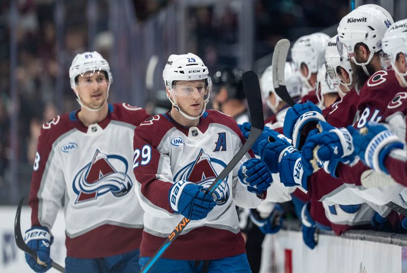 Mar 12, 2026; Seattle, Washington, USA; Colorado Avalanche forward Nathan MacKinnon (29) celebrates a goal with teammates on the bench during the first period against the Seattle Kraken at Climate Pledge Arena. Mandatory Credit: Stephen Brashear-Imagn Images