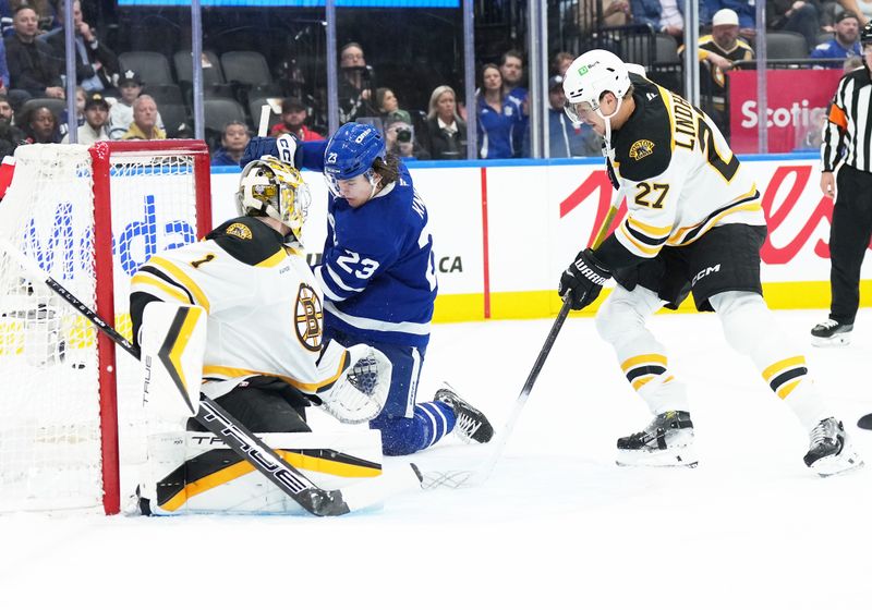 Nov 5, 2024; Toronto, Ontario, CAN; Toronto Maple Leafs left wing Matthew Knies (23) looks for the puck in front of Boston Bruins goaltender Jeremy Swayman (1) during the first period at Scotiabank Arena. Mandatory Credit: Nick Turchiaro-Imagn Imagess